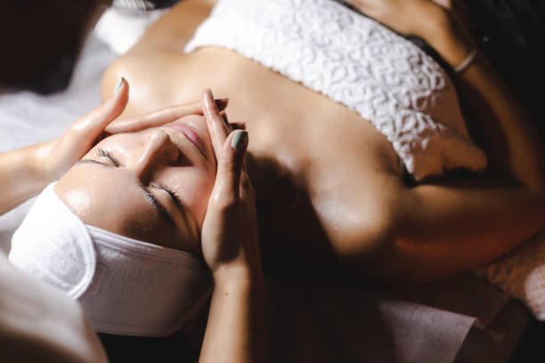 Happy woman receiving a beauty treatment